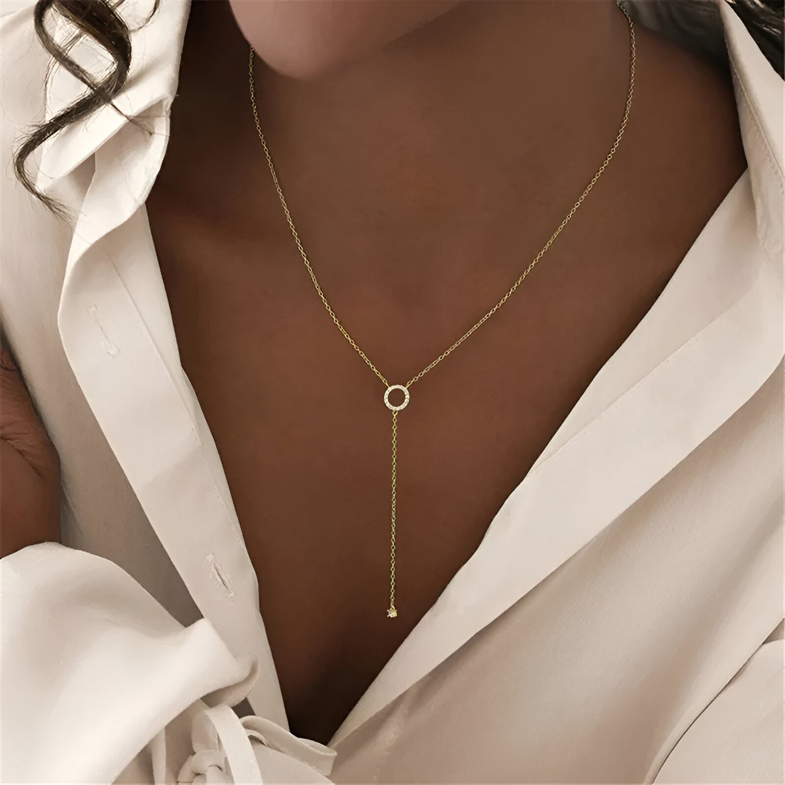 Collier lariat en or jaune et diamants naturels porté au coup d'une femme.