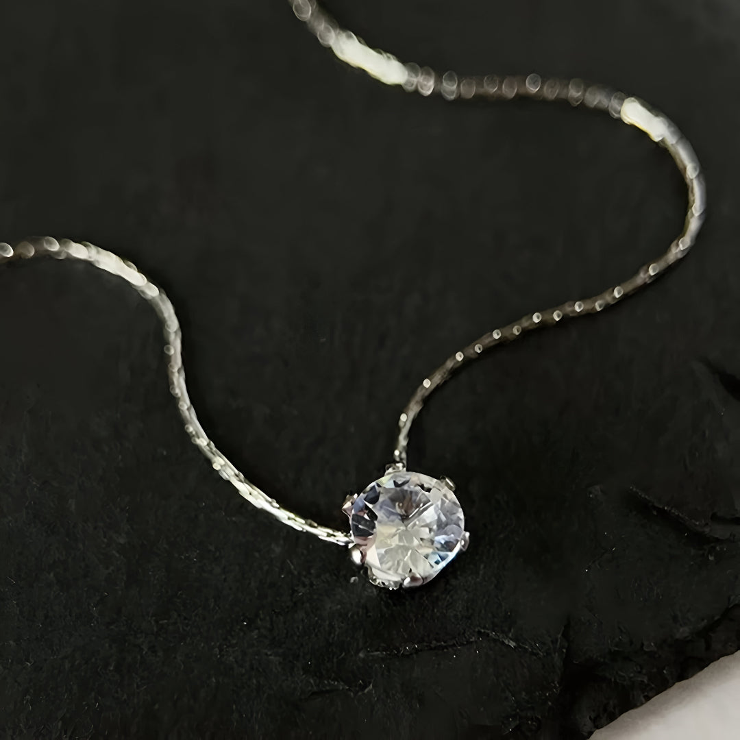 Collier zircon solitaire sur fond noir, éclat lumineux du plaquage or blanc 18k