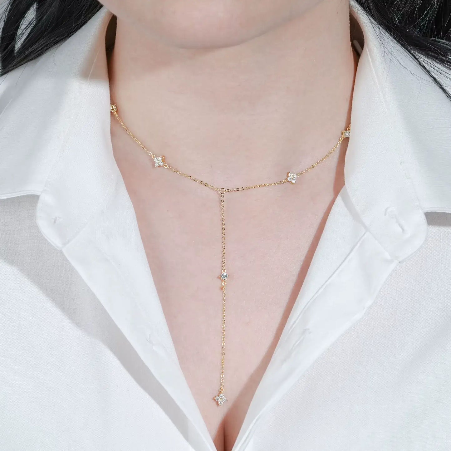 Sautoir fleurs maille dorée lumineuse en argent 925 plaqué or jaune et diamants porté au cou d'une femme vue de face.