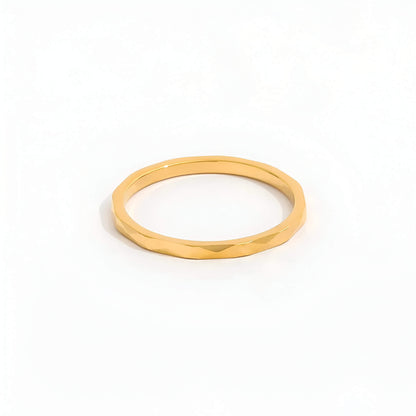 Alliance discrète multi-facettes dorées Noa en acier plaqué or jaune 14K sur fond blanc.