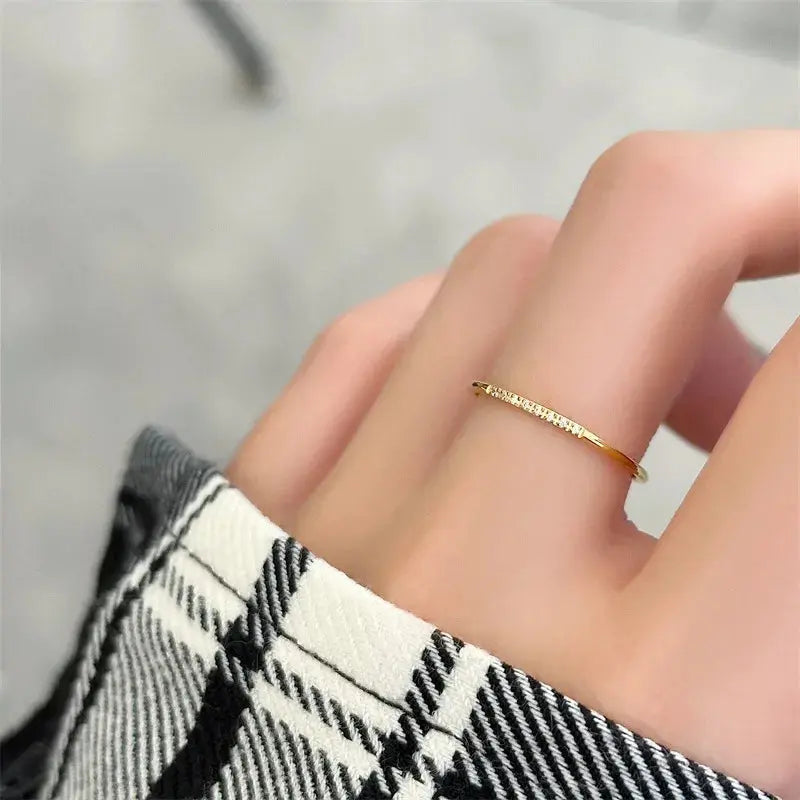 Alliance fine en or Petites Gemmes variante huit pierres portée au doigt d'une femme.