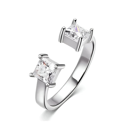 Bague ouverte en or blanc et diamants synthétiques sur fond blanc.