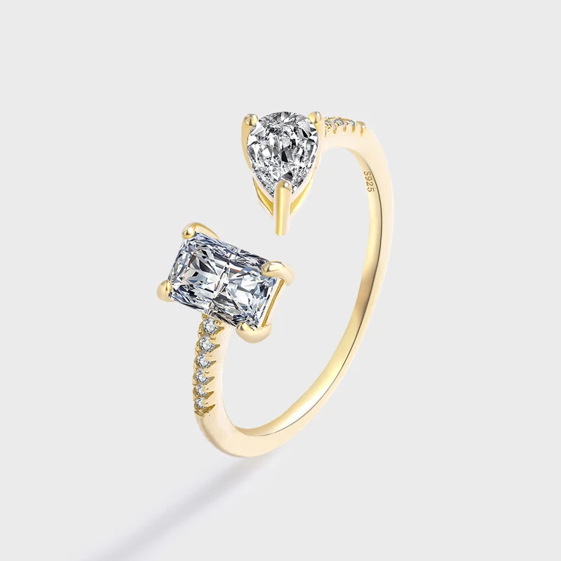 Bague ouverte en or jaune et diamants naturels sur fond gris clair.