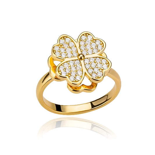 Bague rotative en acier doré et oxydes de zirconium sur fond blanc.