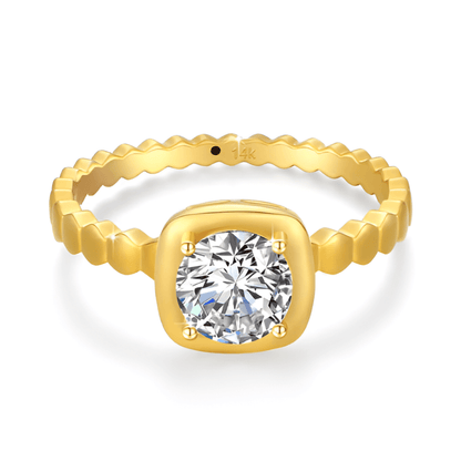Bague solitaire granulé en or jaune et diamant synthétique sur fond blanc.