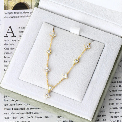 Bracelet breloque fleur en argent 925 plaqué or jaune et diamants scintillants rangé dans son écrin vue du dessus.