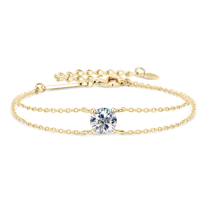 Bracelet double maile dorée en argent 925 plaqué or jaune et diamant solitaire sur fond blanc.