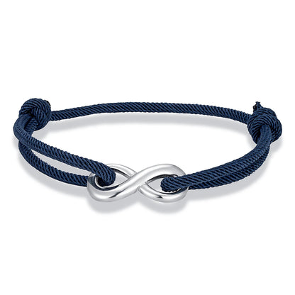 Bracelet infini ajustable en acier inoxydable blanc et cordon bleu foncé sur fond blanc.