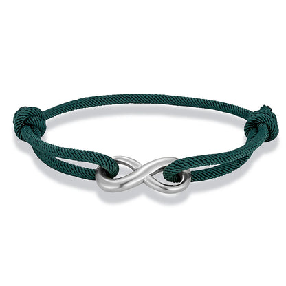 Bracelet infini ajustable en acier inoxydable blanc et cordon vert foncé sur fond blanc.