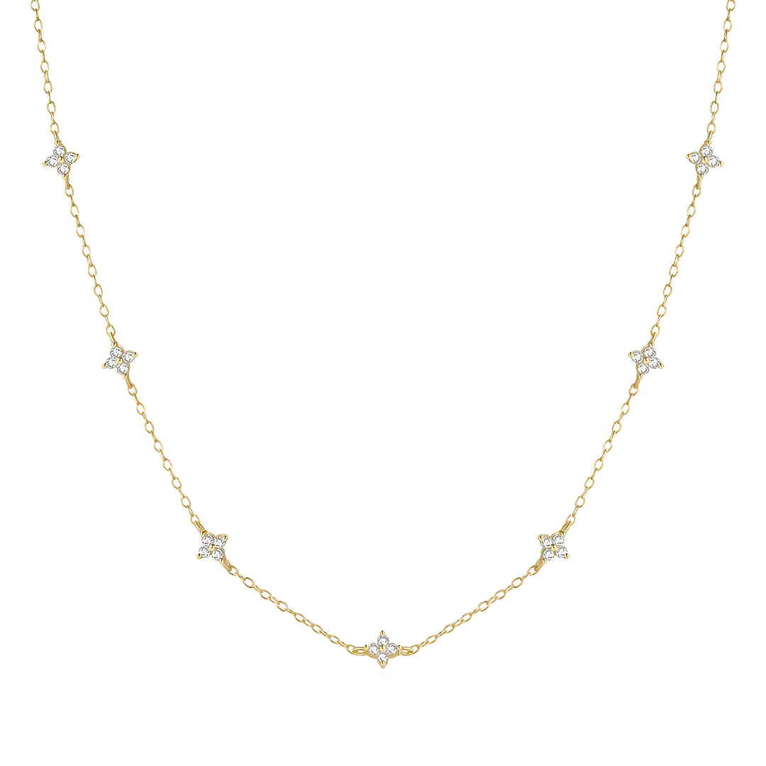 Chaîne fleurs de diamants naturels en or jaune sur fond blanc.