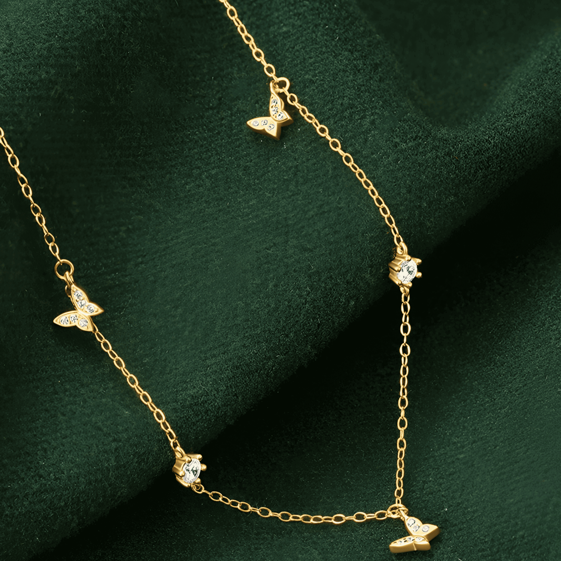 Chaîne papillons en or jaune et diamants naturels posée.