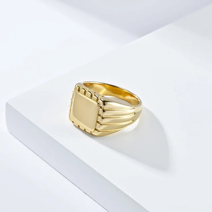 Chevalière pavé rainuré en acier doré vue de côté.