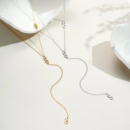 Colliers longs motifs infinis albert en argent 925 plaqué or jaune et plaqué or blanc avec diamants à plat.