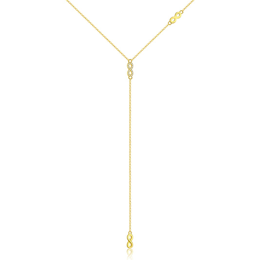 Collier long motif infini albert en argent 925 plaqué or jaune et diamants sur fond blanc.