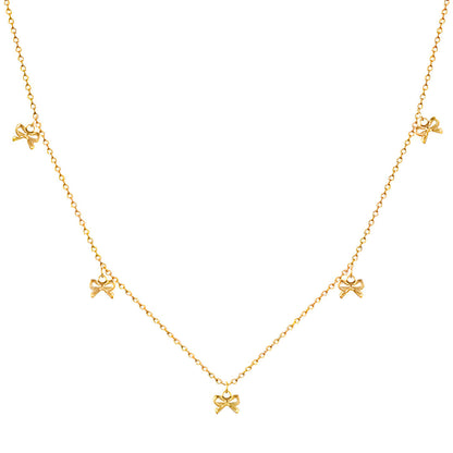 Collier nœud papillon en acier inoxydable plaqué or jaune variante breloques sur fond blanc