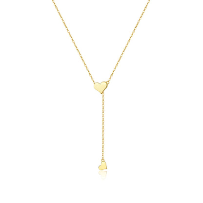 Collier sautoir cœur amovible en argent plaqué or jaune sur fond blanc.