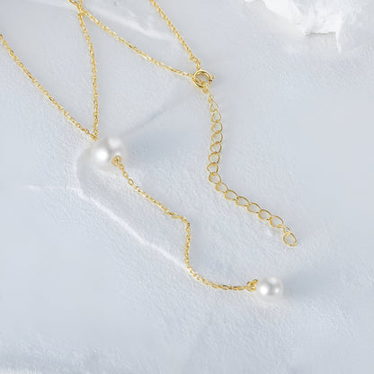 Collier sautoir perle en acier inoxydable plaqué or jaune orné de perles à plat.