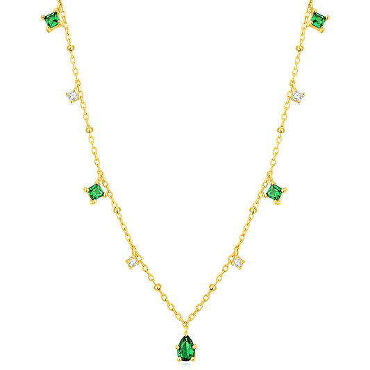 Pendentif à breloques en or jaune et diamants naturels sur fond blanc.