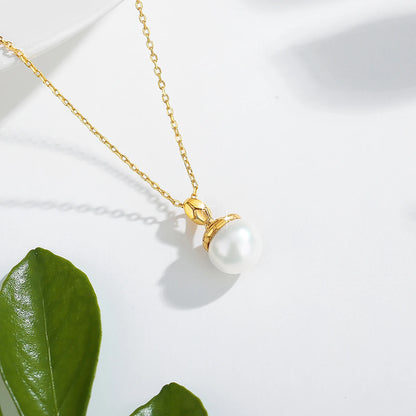 Pendentif cobra doré Sarah en or jaune 18K et perle naturelle ovale nacrée vue du dessus.