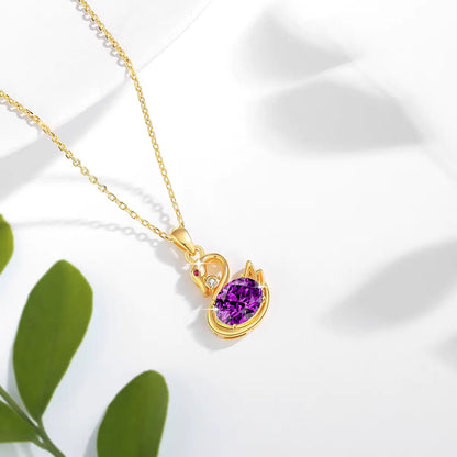 Pendentif cygne améthyste impérial Livie en or jaune 18K monté d'un diamant brillant et d'un rubis vue du dessus.