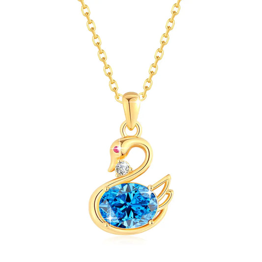 Pendentif cygne topaze radieuse en or jaune 18K orné d'un rubis et d'un diamant sur fond blanc.