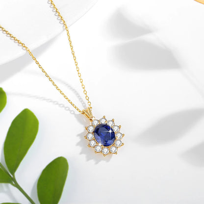 Pendentif halo saphir ovale en or jaune 18K rayonnant et diamants ronds vue du dessus.
