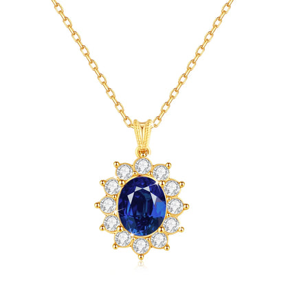 Pendentif halo saphir ovale en or jaune 18K et diamants ronds sur fond blanc.