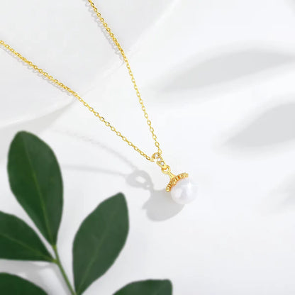 Pendentif lampe royale perle ronde Lumos en or jaune 18K et diamants étincelants vue du dessus.