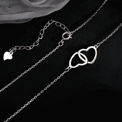 Collier pendentif fantaisie paire de cœurs en acier plaqué or blanc étiré.