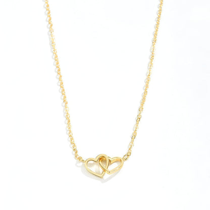 Collier pendentif fantaisie paire de cœurs en acier inoxydable plaqué or jaune vue de face.