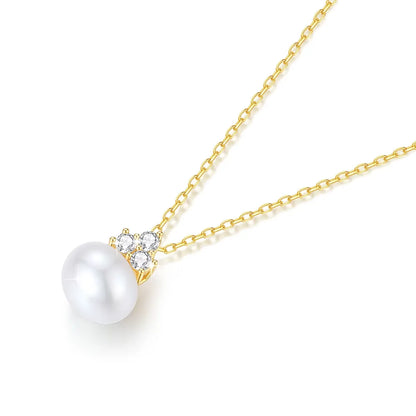 Pendentif perle solitaire en or jaune et trio de diamants synthétiques à plat.