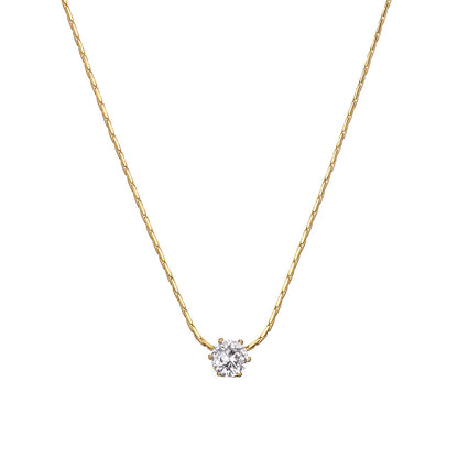 Pendentif solitaire en acier doré et diamant naturel sur fond blanc.