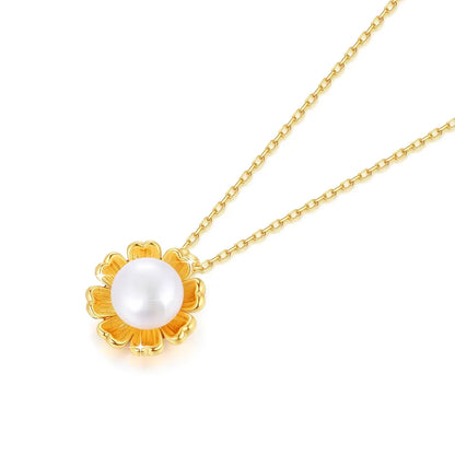 Pendentif fleur de tournesol en or jaune et perle nacrée à plat.