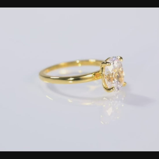 Vue autour de la bague Serres d'Aigle en or 14K, lumière réfléchie sur sol blanc, éclat du zircon cubique