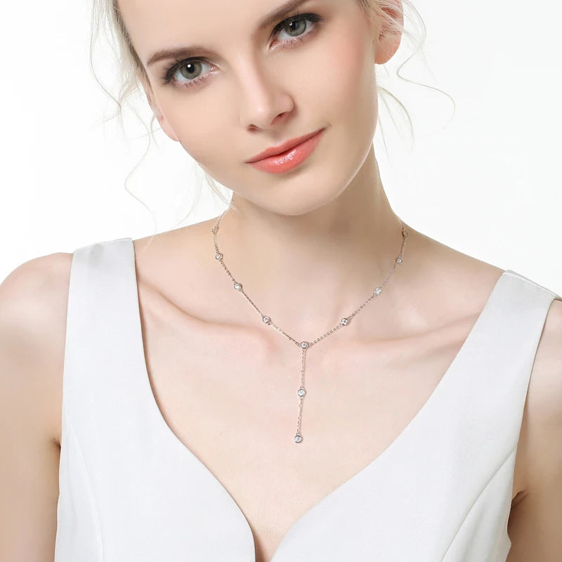 Sautoir court en argent 925 plaqué or blanc et moissanites porté au cou d'une femme.