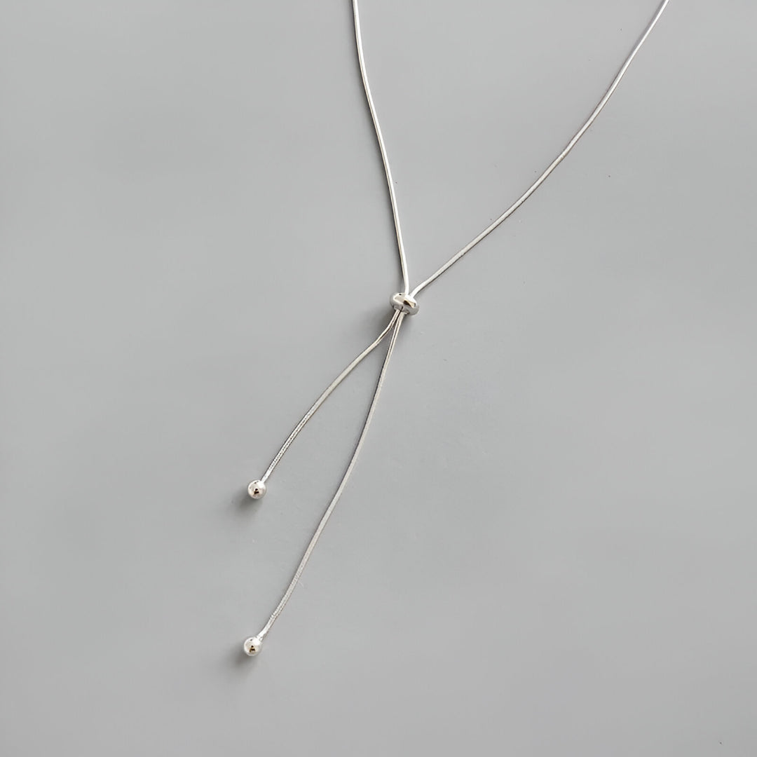 Collier sautoir perle synthétique amovible en acier inoxydable plaqué or blanc à plat.