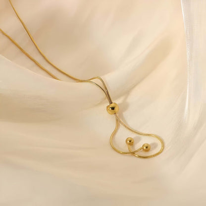 Sautoir perle synthetique amovible en acier doré orné de perle amovible posé.